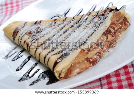 crepes with chocolate syrup and coconut