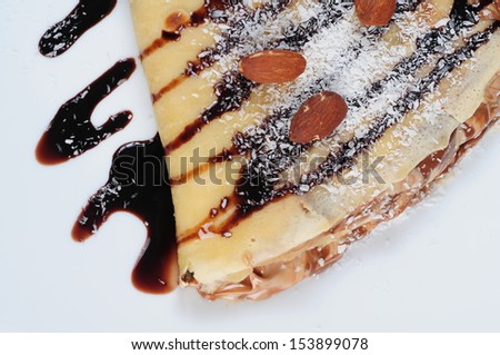 pancake with chocolate syrup,almond and coconut