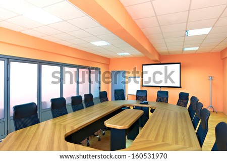 Conference Room With Empty Chairs And A Projector Screen