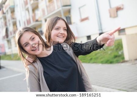 A girl pointing something other girl