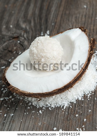 Coconut cakes and fresh coconut on wood
