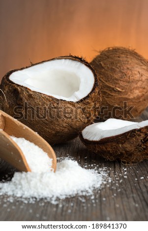 Coconut and grounded coconut flakes on wood