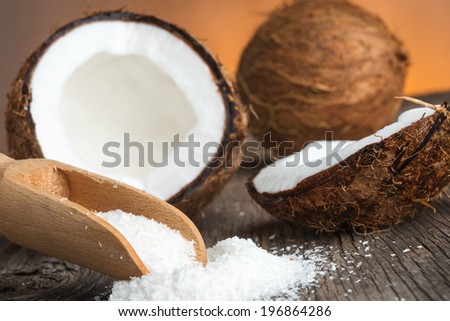 Close up of a coconut and grounded coconut flakes