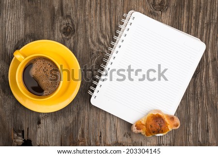 Coffee croissant and notebook, top view