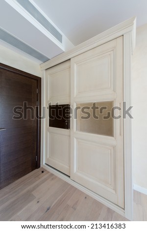 Wooden wardrobe with sliding doors