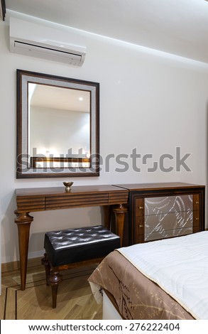 dressing table with large mirror in bedroom interior