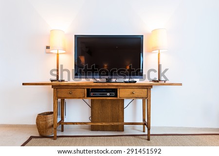 Flat screen TV at wooden shelf