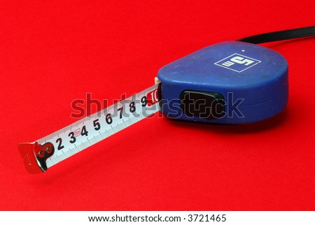 blue measurement tape on red background