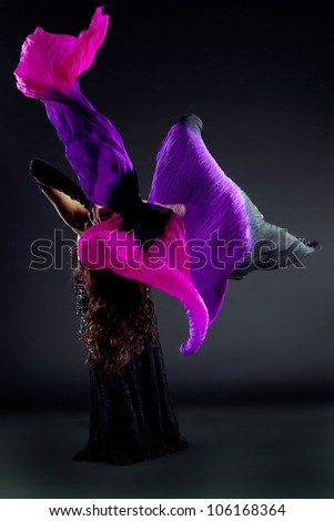 Beautiful young woman dancing oriental dance