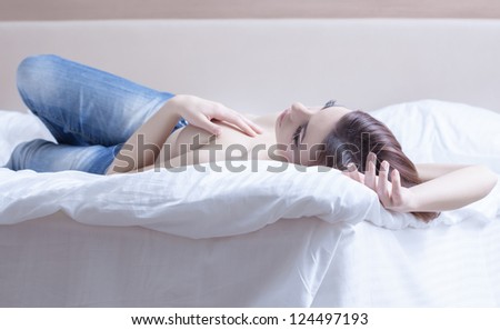 Sexy woman relaxing in bedroom