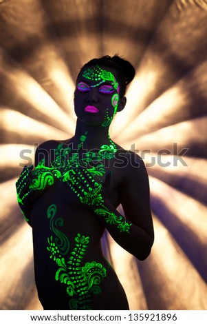 Image of beautiful naked girl with UV disco makeup