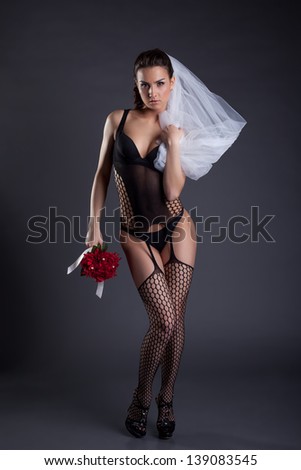 Sexy bride posing in black lingerie and veil