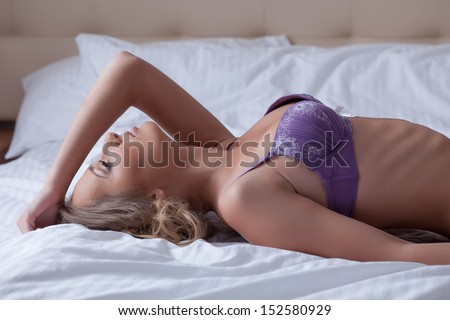 Profile of beautiful girl posing in lilac lingerie