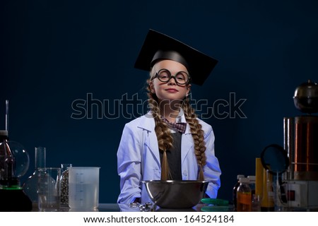 Image of cute little girl posing in graduate hat