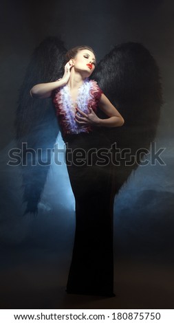 Voluptuous woman posing similitude of fallen angel