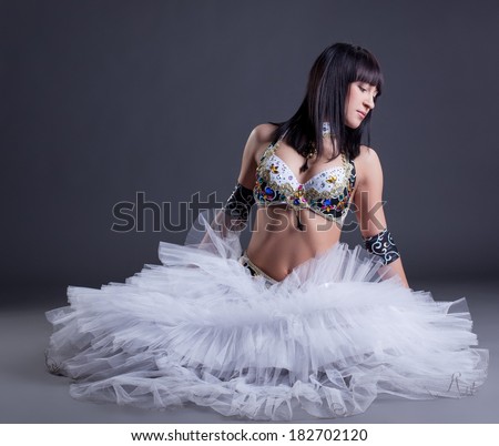 Artistic oriental dance performer posing in studio