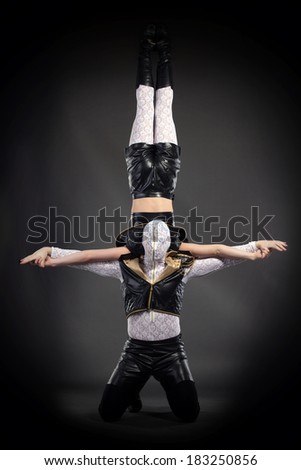 Shot of acrobatic stunt performed by go-go dancers