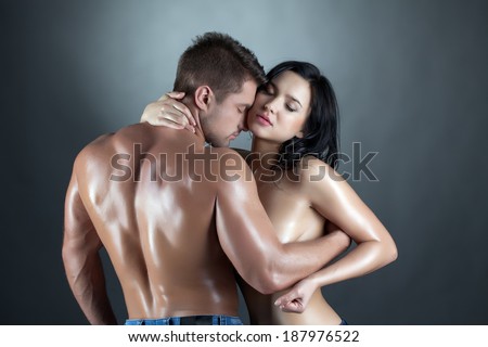 Beautiful young married couple hugging at camera