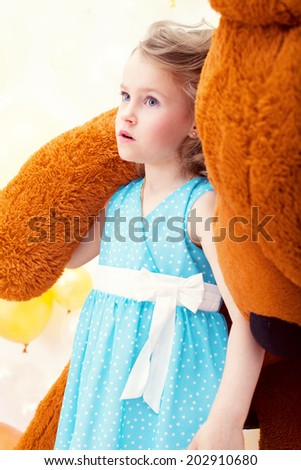 Beautiful little girl posing with teddy bear