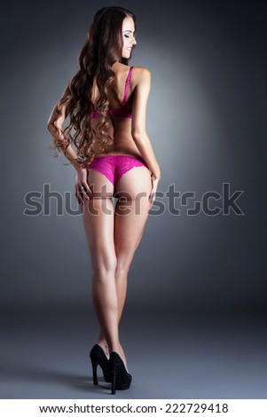 Sexy model in pink underwear posing back to camera