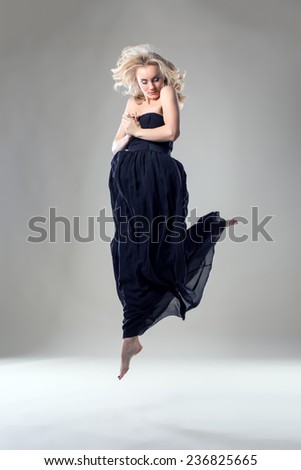 Beautiful blonde dancer posing in jump