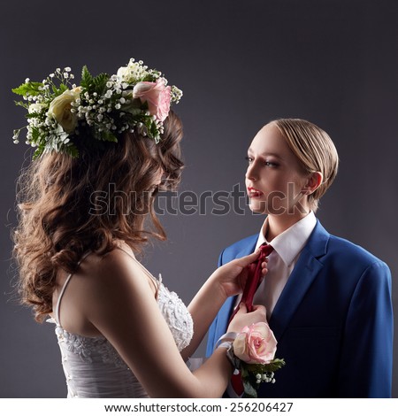 Gay wedding. Bride straightens groom\'s tie