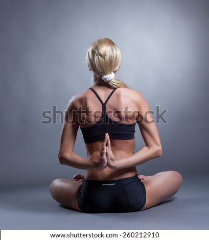 Flexible woman folded hands behind her back