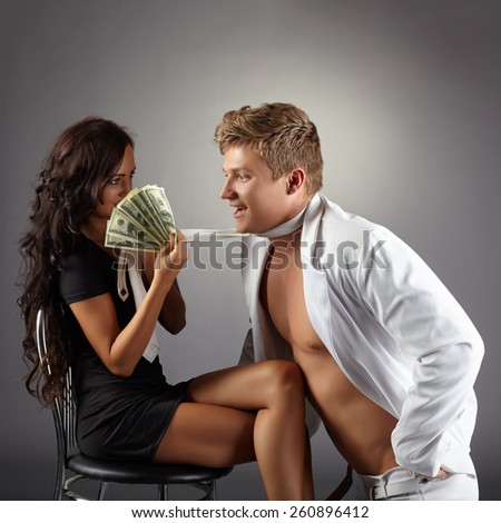 Sexy girl attracts dancer with pack of dollars