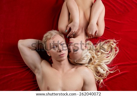 Shot of muscular man and hot blonde in bed
