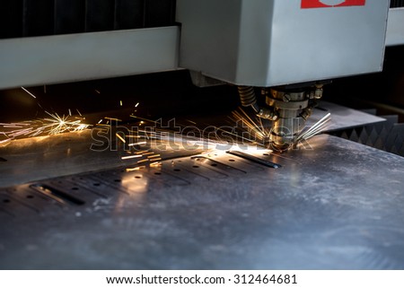 Modern automated machine laser cutting metal sheet