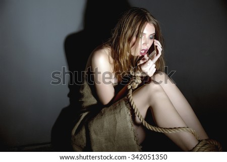 Concept. Kidnapped model asks for help on phone