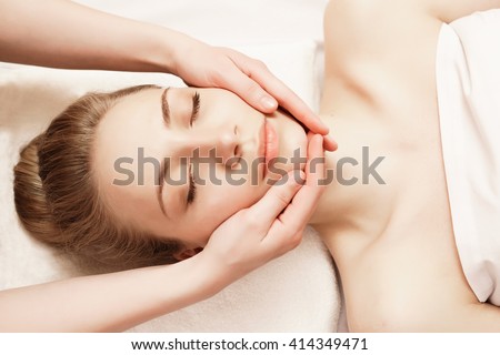 Spa. Woman enjoying anti-aging facial massage