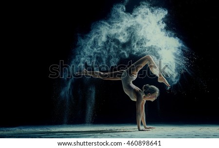 Graceful woman dancing in cloud of dust
