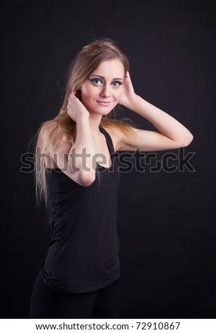 Young beauty blond girl in black tank top