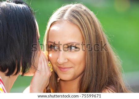 Two beauty woman talk a secret