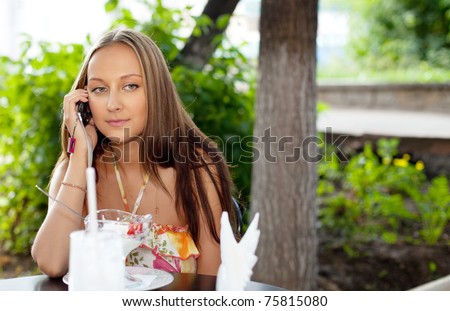 Beauty young woman in summer cafe talk a cell