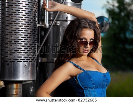 sexy girl in jeans stand near steel truck cabin