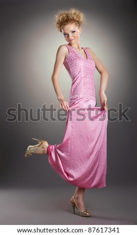 Pretty blonde woman dance in rose clothes