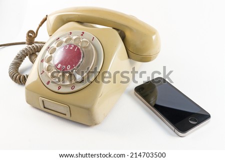 old telephone and smart phone on white background