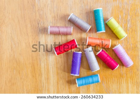 Spools of threads on  wooden table