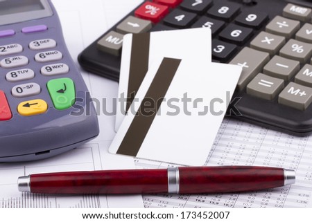Business still-life: payment terminal, credit cards, calculator, pen
