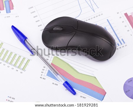 Business still-life of a pen, diagram, computer mouse