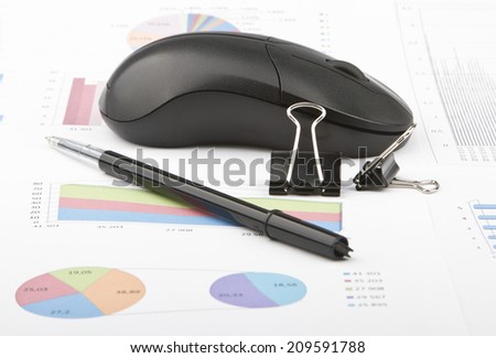 Business still-life of a black pen, paperclips, computer mouse