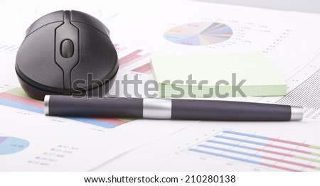Business still-life of a black pen, computer mouse