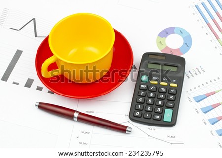 Business still life of pen, cup, saucer, calculator