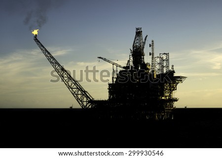 Beautiful silhouette view of an oil processing platform during drilling operation at sea