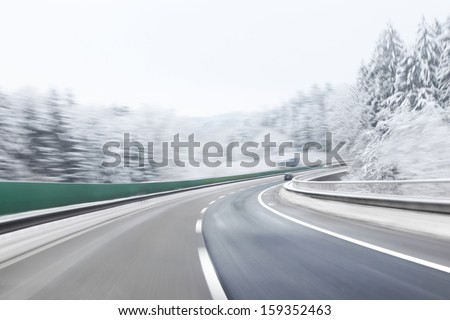Danger and fast turn at the icy snow road. Motion blur visualizies the speed and dynamics.