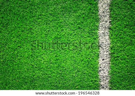 Artificial soccer grass field detail with white goal line. Vintage filter effect used.