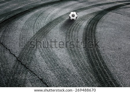Soccer ball with shadows on a dangerous road. Abstract asphalt road with illustrated soccer ball background.