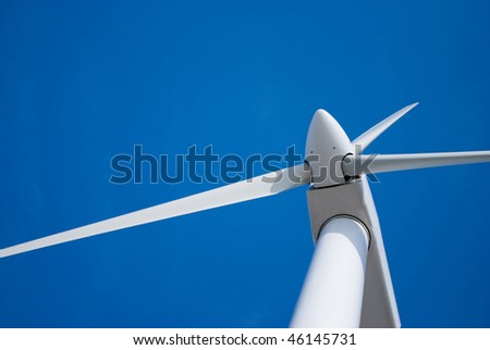 wind turbine propeller blades against blue sky, space for copy